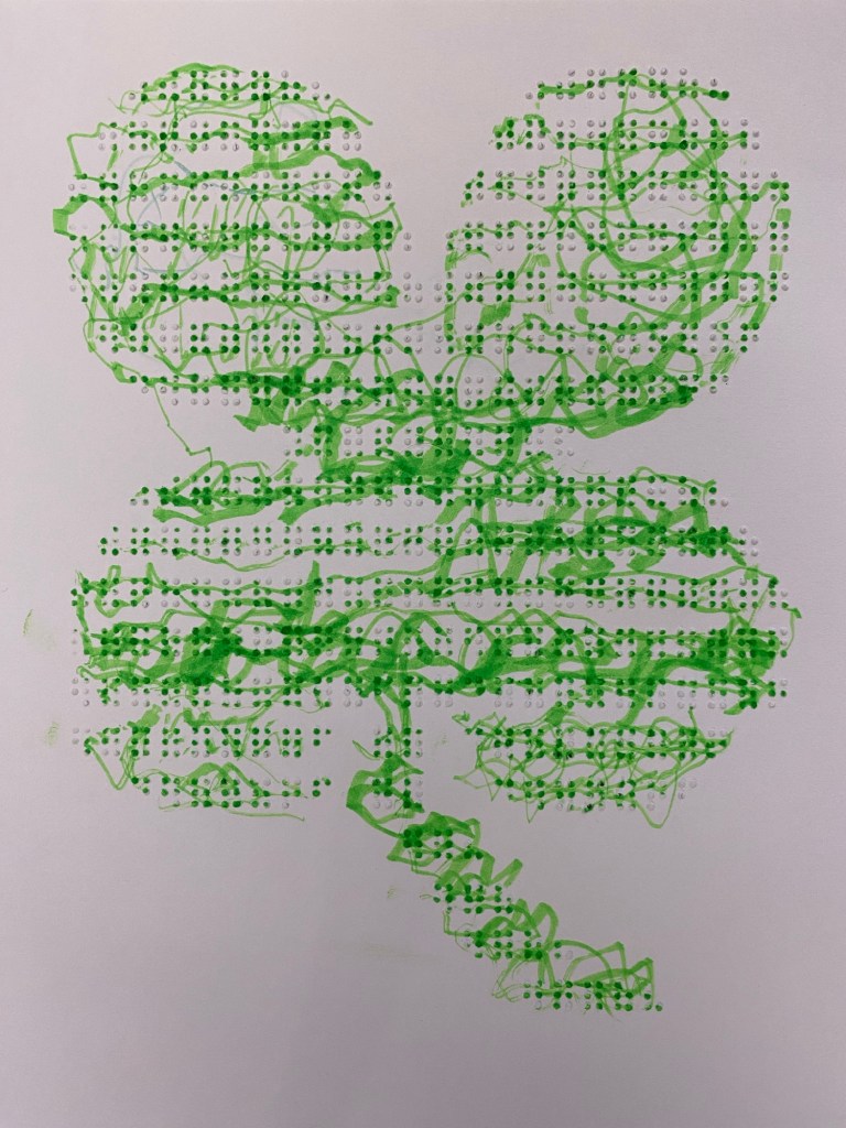 A tactile Shamrock made from Braille symbols and letters. It has been colored over with a green highlighter which gives it a bright fluorescent appearance. The braille is visible through the highlighter. ￼
