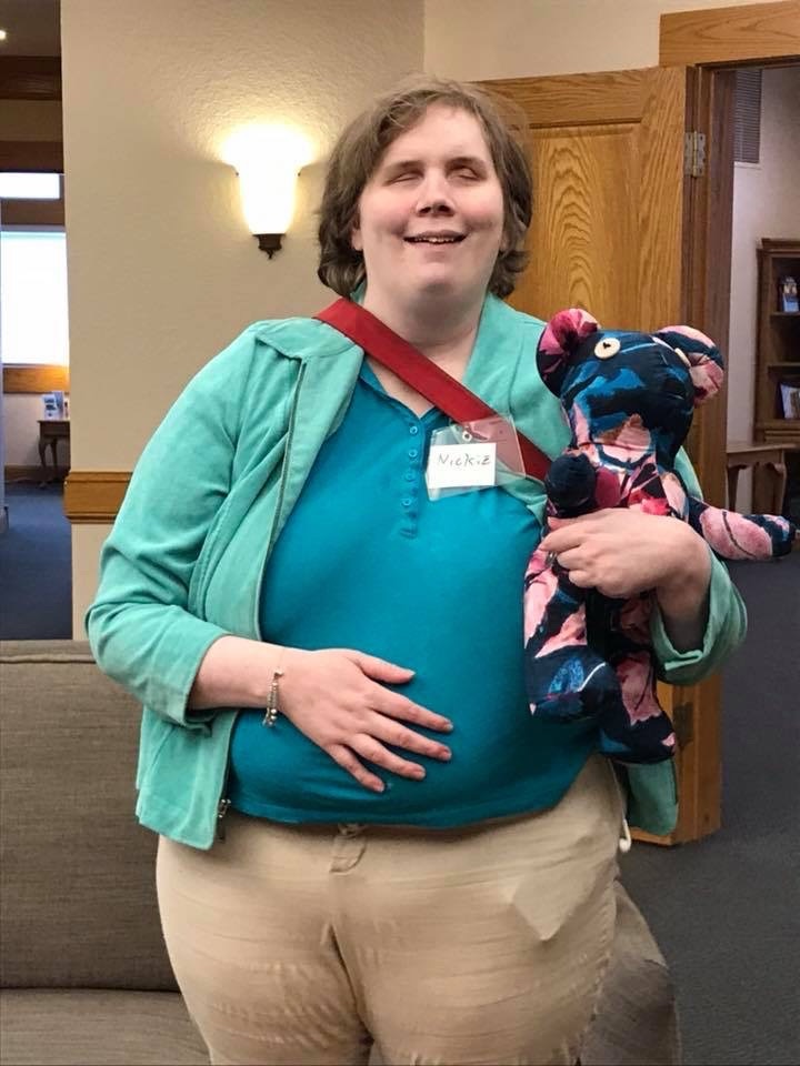 Nickie holds a teddy bear made from a pink and blue shirt. This is the bear known as Mamma bear. 
