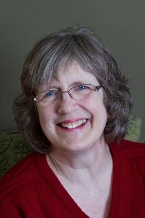 Mom smiling and wearing a red sweatter. 